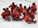 Team Canada players celebrate after the Para Ice Hockey Semifinal Match between Team Canada and Team People's Republic of China on day seven of the Milano Cortina 2026 Winter Paralympic Games at Milano Santagiulia Ice Hockey Arena on March 13, 2026 in Milan, Italy.