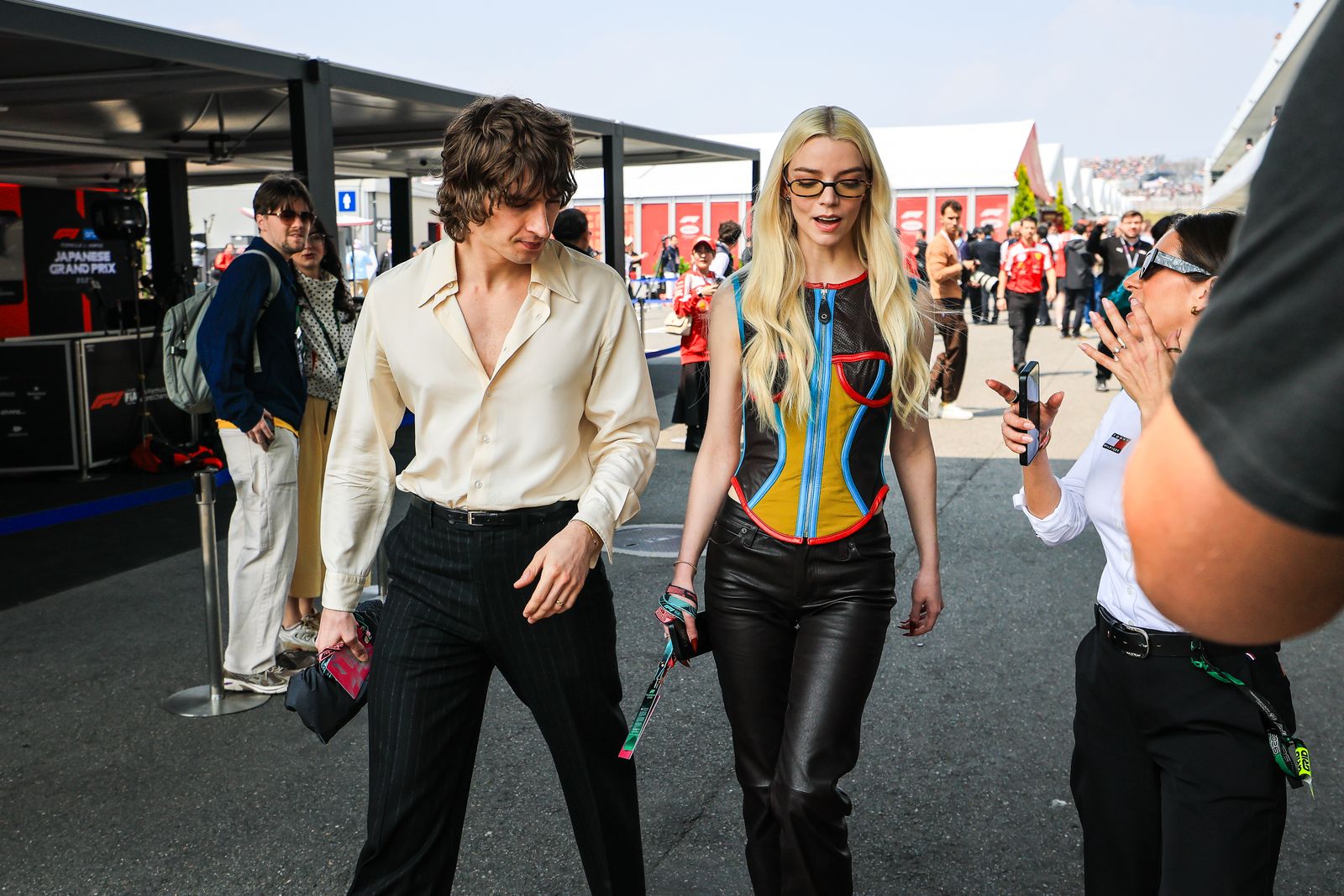SUZUKA JAPAN  MARCH 29 Anya TaylorJoy and Malcolm McRae walk in the paddock during the F1 Grand Prix of Japan at Suzuka...