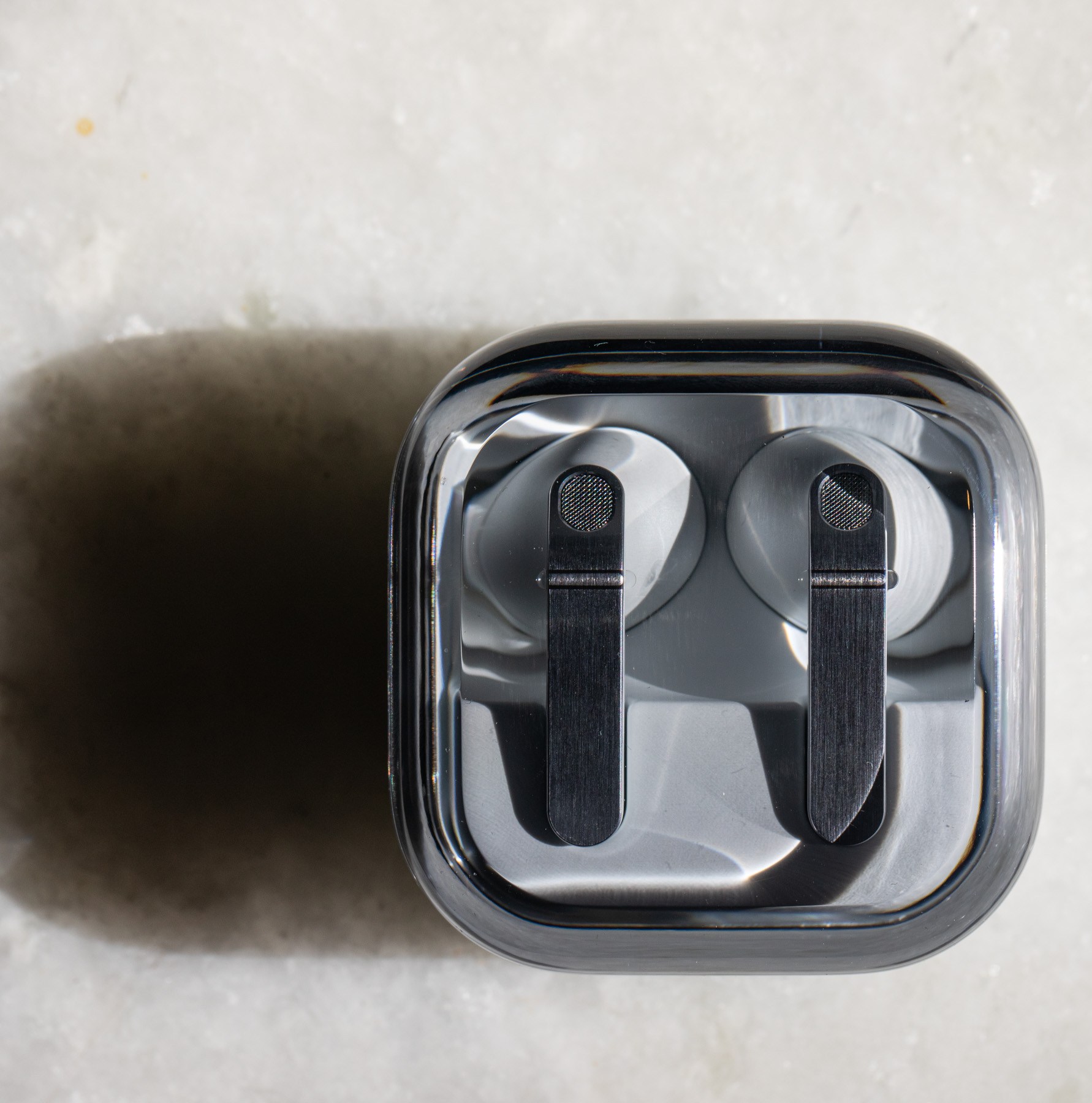 The Samsung Galaxy Buds 4 Pro in their charging case on a white tabletop.