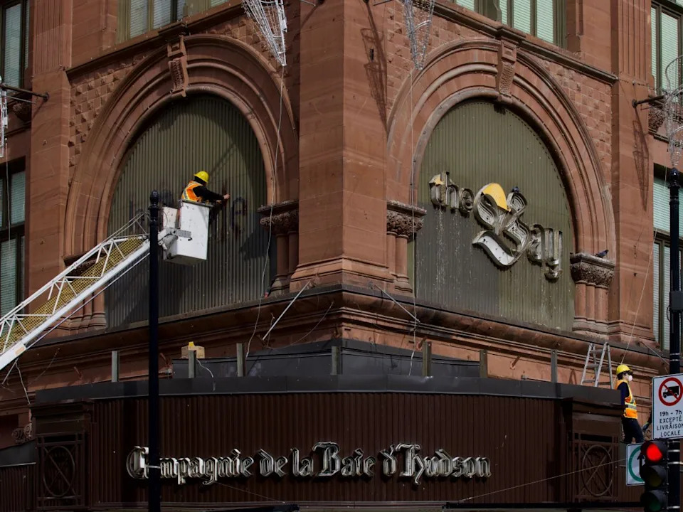  A worker is seen taking down the letters of The Bay on the old store’s facade in downtown Montreal on Monday, March 9, 2026.