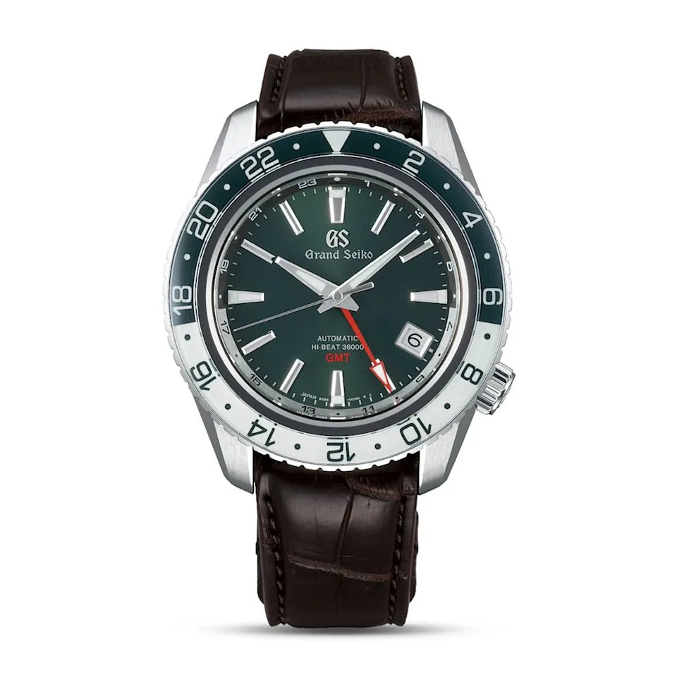 luxury automatic grand seiko gmt watch with a dark green dial and brown leather strap