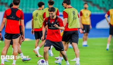 Iraq national team players warm-up on a football pitch