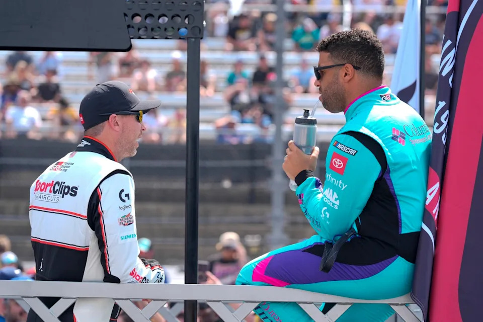 NASCAR Cup Series driver Denny Hamlin (11) chats with driver Bubba Wallace (23) during pre race intros during the Goodyear 400 at Darlington Raceway.Jim Dedmon-Imagn Images