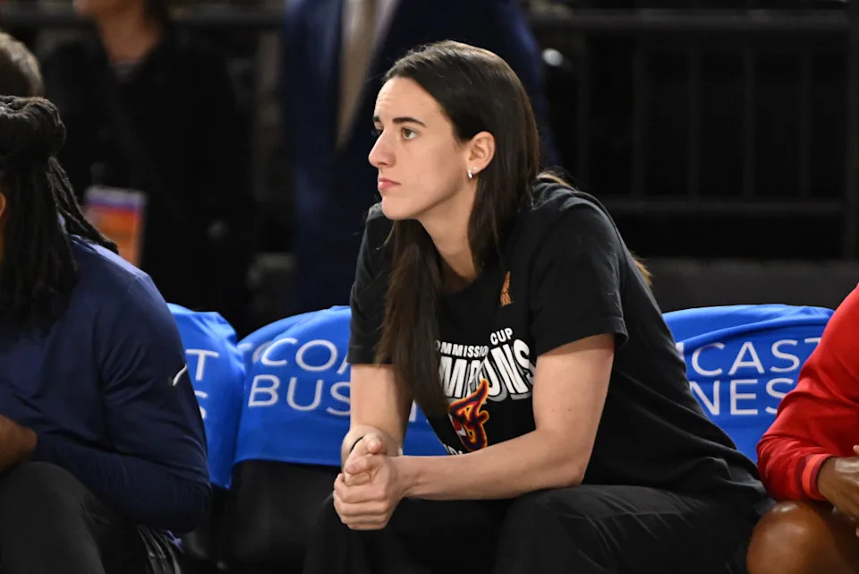 Indiana Fever guard Caitlin Clark (22) looks on from the bench during a game.Rafael Suanes-Imagn Images