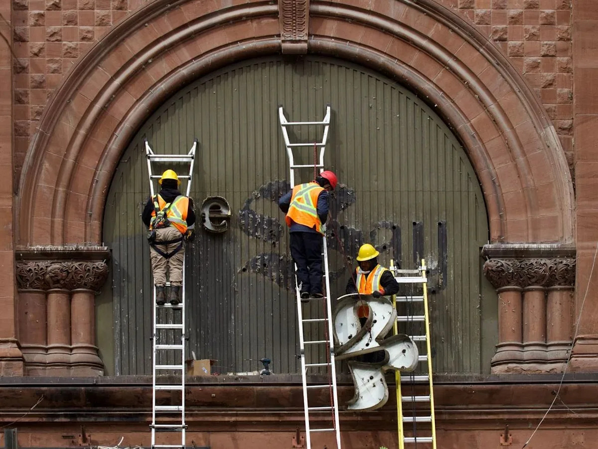 Photos: The Bay's iconic sign dismantled in downtown Montreal