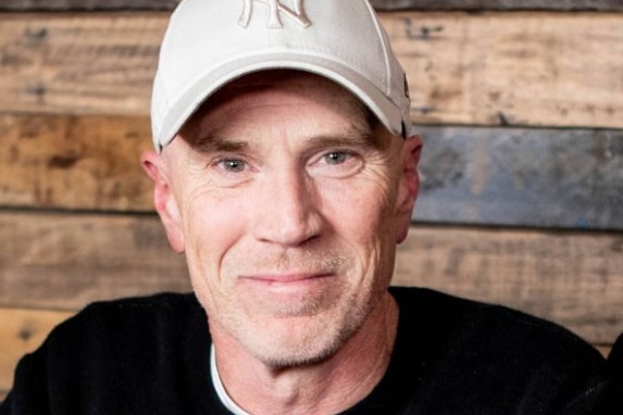 A man in a baseball cap.