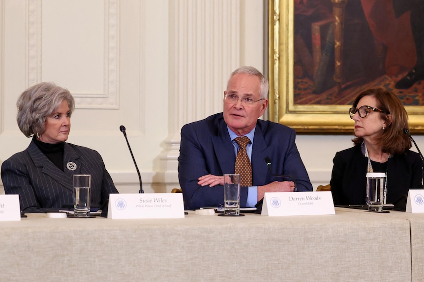 A man at a round table meeting.