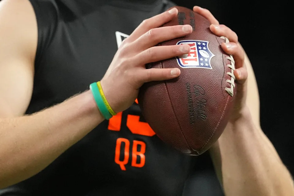 A detail of North Dakota State quarterback Cole Payton (QB15) gripping the ball during the NFL Scouting Combine at Lucas Oil Stadium.