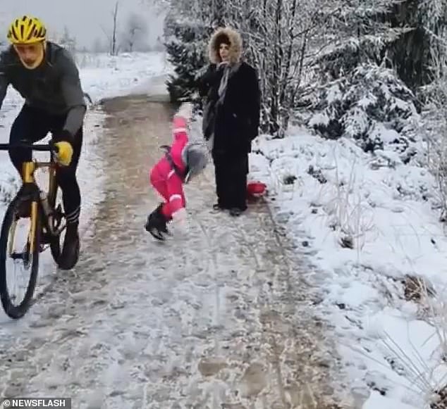 A father who was ordered to pay compensation to a cyclist for filming him as he knocked over his young daughter has finally won his legal battle. The Belgian cyclist (left) went viral after he was filmed kneeing the little girl as he rode past her and her family