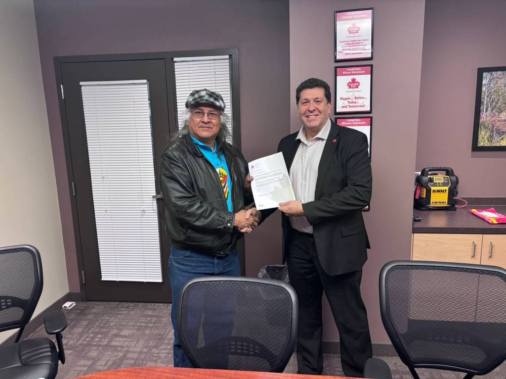 SUPPLIED
Raymond Robinson, grandfather of Nicholas, accepts a letter of apology Friday from Canad Inns HSC General Manager John Saad.