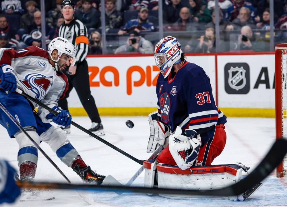 JOHN WOODS / THE CANADIAN PRESS
Winnipeg Jets goaltender Connor Hellebuyck (37) saves the shot from Colorado Avalanche’s Nazem Kadri (91) during first period action in Winnipeg on Saturday.