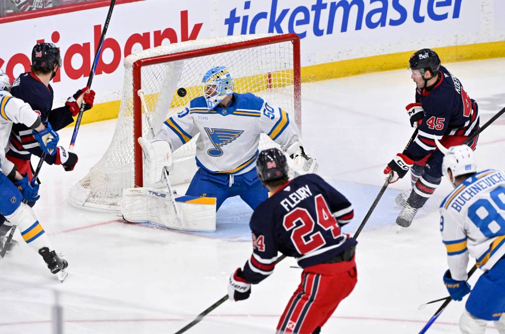 FRED GREENSLADE / THE CANADIAN PRESS
Winnipeg Jets’ Haydn Fleury (24) scores on St. Louis Blues’ goaltender Jordan Binnington (50) the first period in Winnipeg on Sunday.