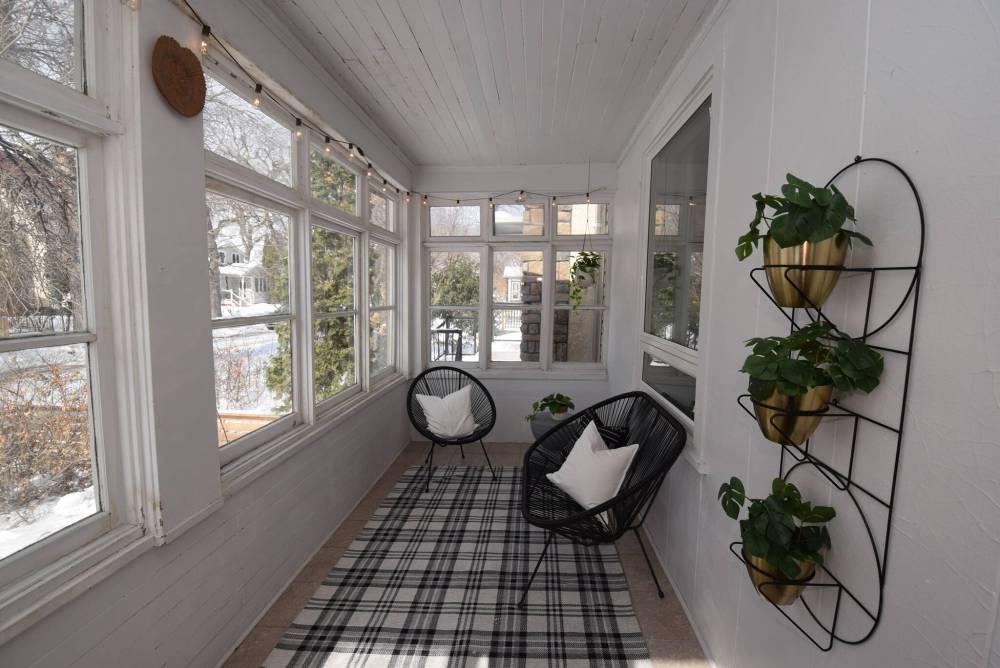 TODD LEWYS / FREE PRESS
The quaint enclosed front porch, which buffers the front of the home from winter winds, is an ideal spot to sit and relax during spring, summer and fall.