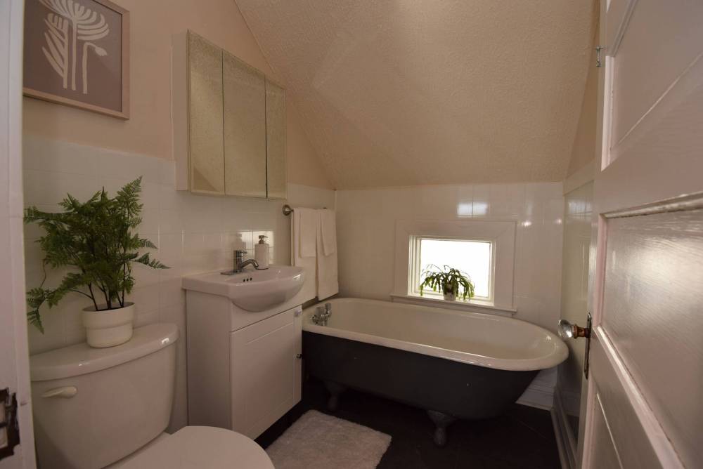TODD LEWYS / FREE PRESS
A classic claw-foot tub serves as the focal point of the tastefully updated main bathroom, with a window behind the tub allowing in natural light.