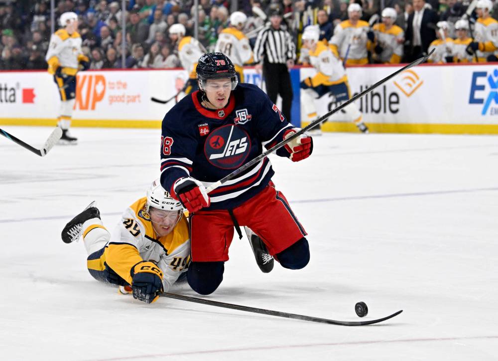 Fred Greenslade / THE CANADIAN PRESS
Nashville Predators’ Reid Schaefer reaches for the puck around Winnipeg Jets’ Jacob Bryson during the first period.
