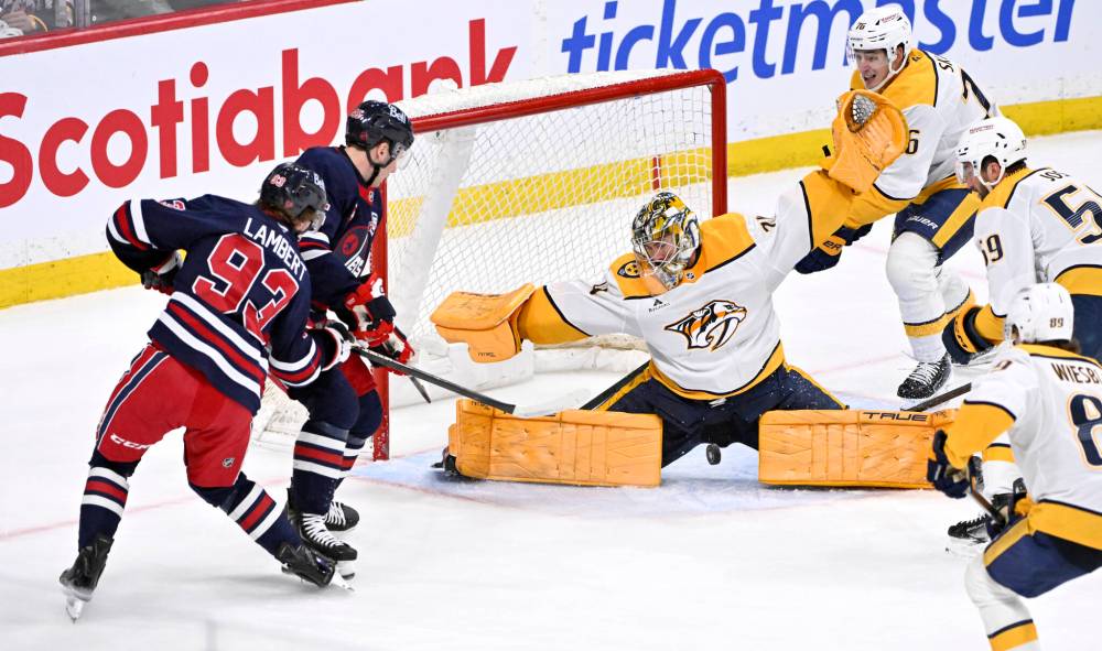Fred Greenslade / THE CANADIAN PRESS
Nashville Predators goaltender Juuse Saros makes a save on Winnipeg Jets’ Brad Lambert during the third period of the Predators 4-3 shootout win, Tuesday in Winnipeg.