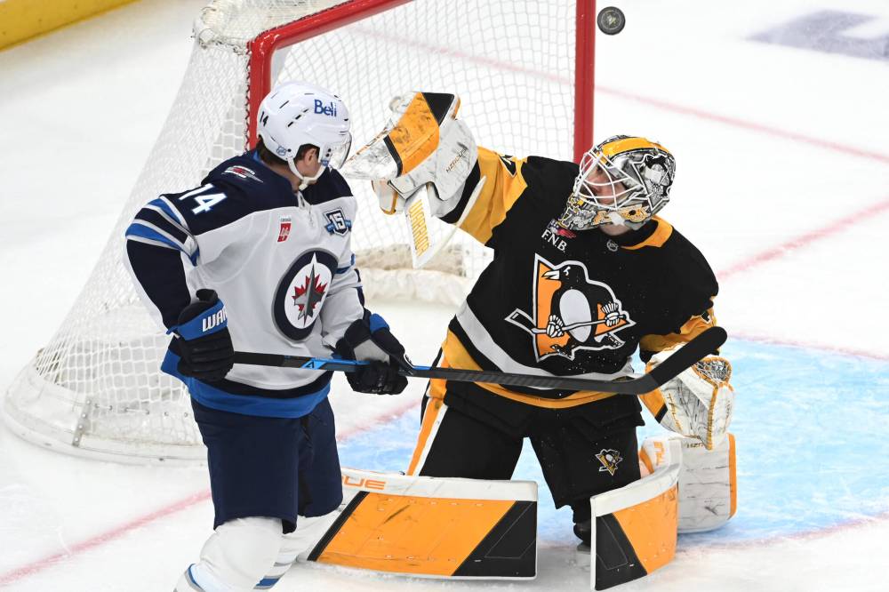 PHILIP G. PAVELY / THE ASSOCIATED PRESS
Pittsburgh Penguins goalie Arturs Silovs (37) makes a save under pressure from Winnipeg Jets right wing Gustav Nyquist (14) during the first period Saturday in Pittsburgh.