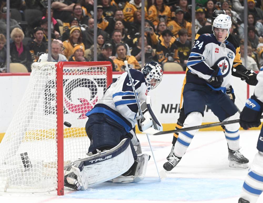 PHILIP G. PAVELY / THE ASSOCIATED PRESS
Winnipeg Jets goalie Connor Hellebuyck (37) gives up a goal to Pittsburgh Penguins defenceman Erik Karlsson as defenceman Haydn Fleury (24) looks on during the second period Saturday in Pittsburgh.