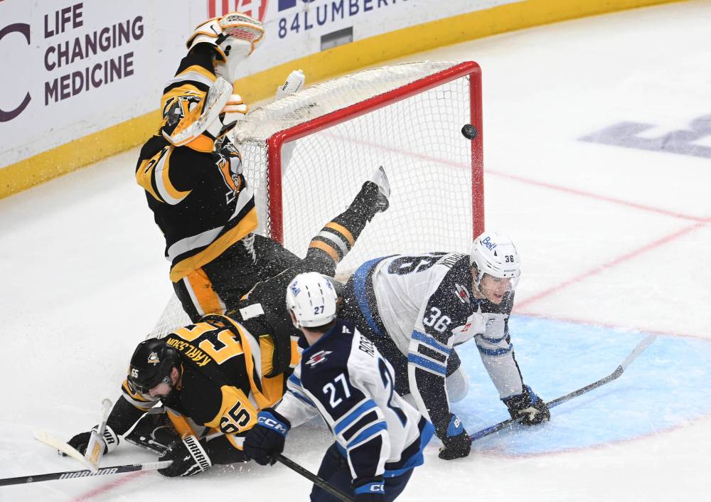 PHILIP G. PAVELY / THE ASSOCIATED PRESS
Winnipeg Jets centre Morgan Barron (36) scores on Pittsburgh Penguins goalie Arturs Silovs (37) while crashing into defenceman Erik Karlsson (65) as right wing Isak Rosen (27) looks on during the first period on Saturday in Pittsburgh.