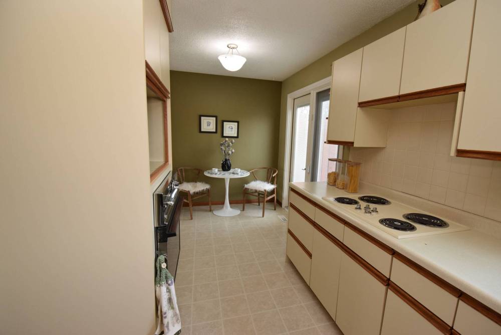 Todd Lewys / Free Press
A dining area at the far end of the kitchen is next to a patio door leading out to a large deck that overlooks the fenced backyard.