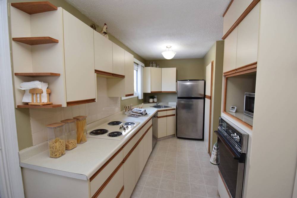 The tidy, well-lit galley kitchen is highly functional space.