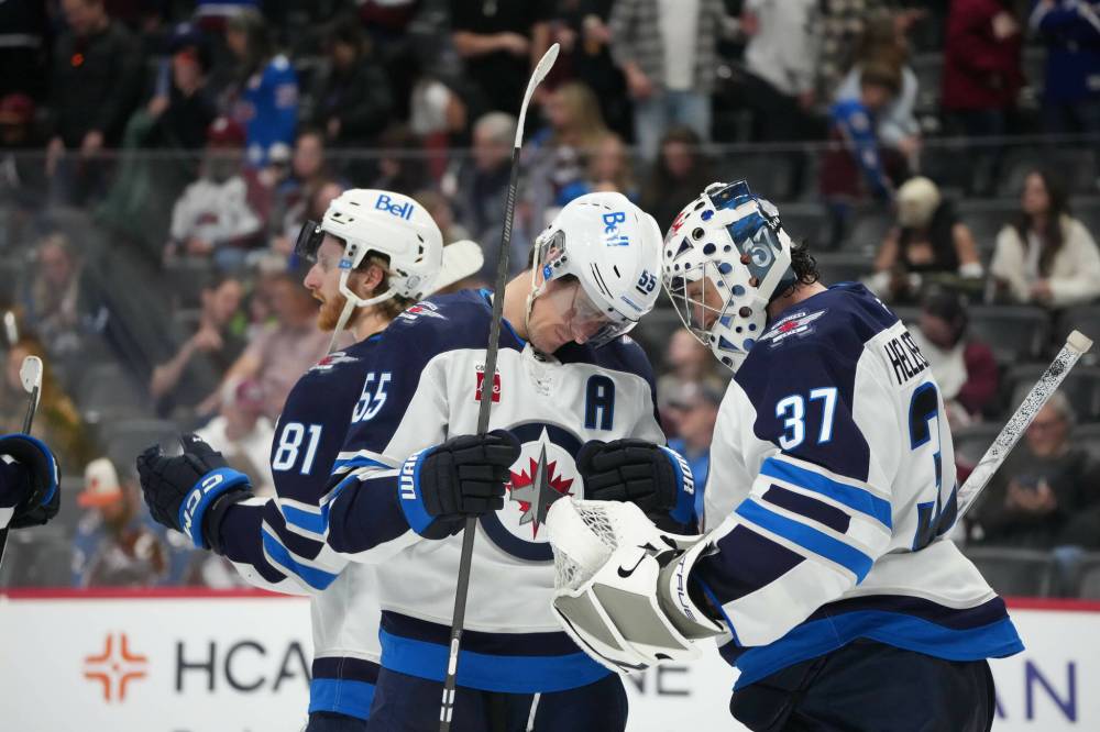DAVID ZALUBOWSKI / THE ASSOCIATED PRESS
Winnipeg Jets centre Mark Scheifele (55) congratulates goaltender Connor Hellebuyck (37) after defeating the Colorado Avalanche Saturday in Denver.