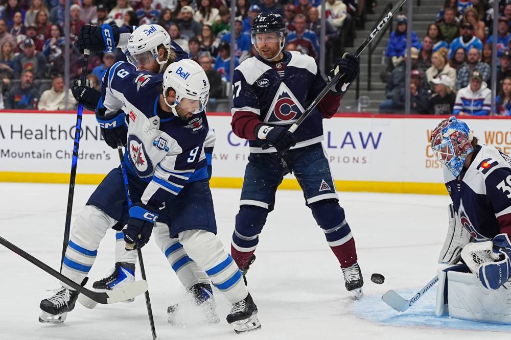 DAVID ZALUBOWSKI / THE ASSOCIATED PRESS
Winnipeg Jets left wing Alex Iafallo (9) shoots the puck past Colorado Avalanche defenceman Brett Kulak (27) as Avalanche goaltender MacKenzie Blackwood makes a stop in the second period Saturday in Denver.