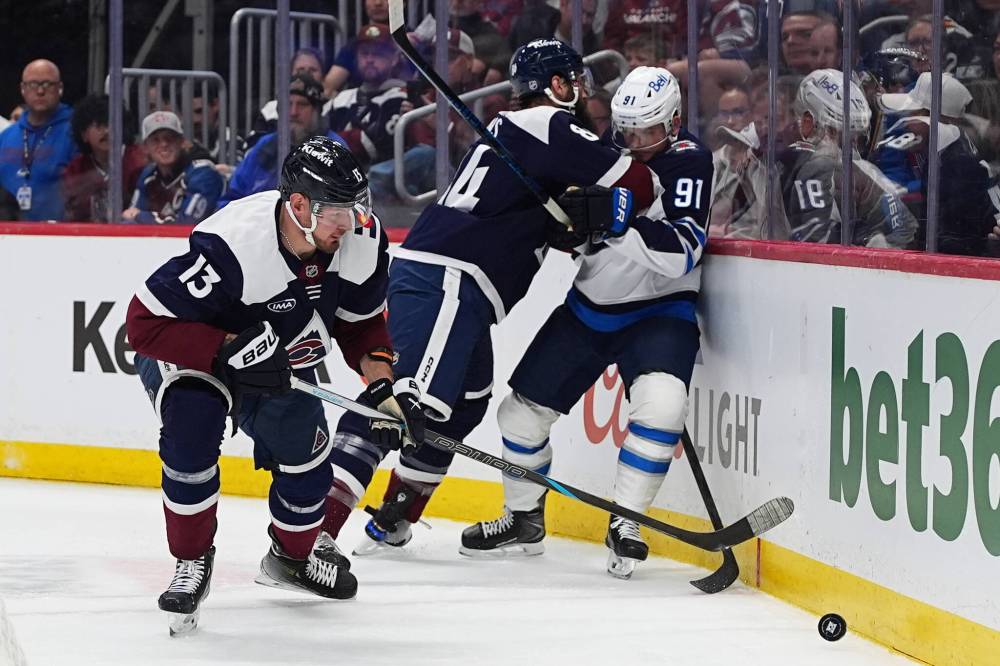 DAVID ZALUBOWSKI / THE ASSOCIATED PRESS
Colorado Avalanche right wing Valeri Nichushkin, left, collects the puck as defenceman Brent Burns, back left, checks Winnipeg Jets center Cole Perfetti (91) in the second period Saturday in Denver.