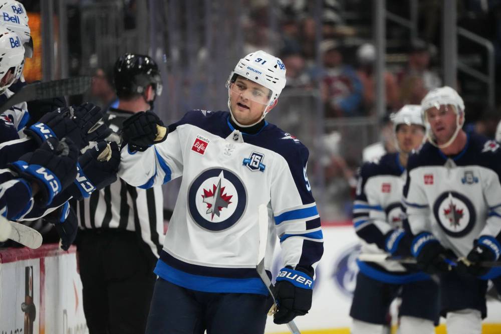 DAVID ZALUBOWSKI / THE ASSOCIATED PRESS
Winnipeg Jets centre Cole Perfetti (91) is congratulated as he passes the team box after scoring against the Colorado Avalanche in the third period Saturday in Denver.