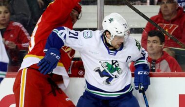Abbotsford Canucks captain Chase Wouters battles for the puck along the boards during AHL action on Sunday (March 1). (Abbotsford Canucks photo)