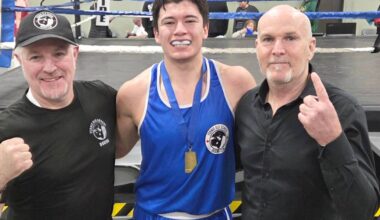 Coaches Mike Johnson and Cam Carr from Fernie Old School Boxing Club stand with elite novice Riley Barr at Provincials in Alberta (Submitted)