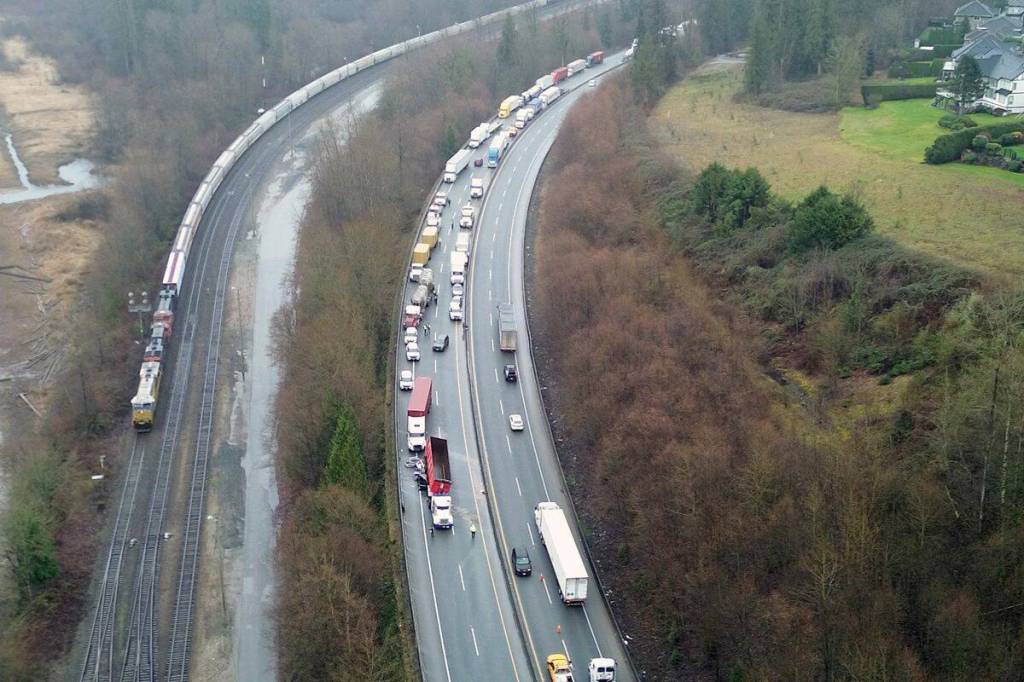 The crash involved two semi-trucks and two cars, with one car wedged under one of the semi-trucks while the other was partially under it. (1st Due Media/ Contributed to Surrey Now-Leader)