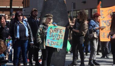 Protesters stop at the intersection of Powell and Main streets in Vancouver to listen to speeches on April 14, 2023 during an event marking the seventh anniversary of the toxic drug deaths in B.C. (Lauren Collins/Black Press Media)