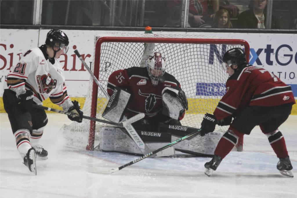 Red Deer Rebels goaltender makes a stop during a game against the Calgary Hitmen at the Marchant Crane Centrium on Saturday, March 14. (Photo by Sean McIntosh/Advocate staff)