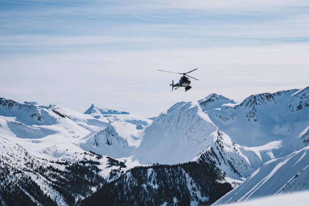 A helicopter with Great Canadian Heli-Skiing flies through the Columbia Mountains, in a photo posted May 28, 2020. (Photo courtesy Great Canadian Heli-Skiing/Facebook)