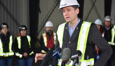 Premier David Eby takes questions from the media during a stop at an industrial site under construction in Maple Ridge. (Neil Corbett/The News)