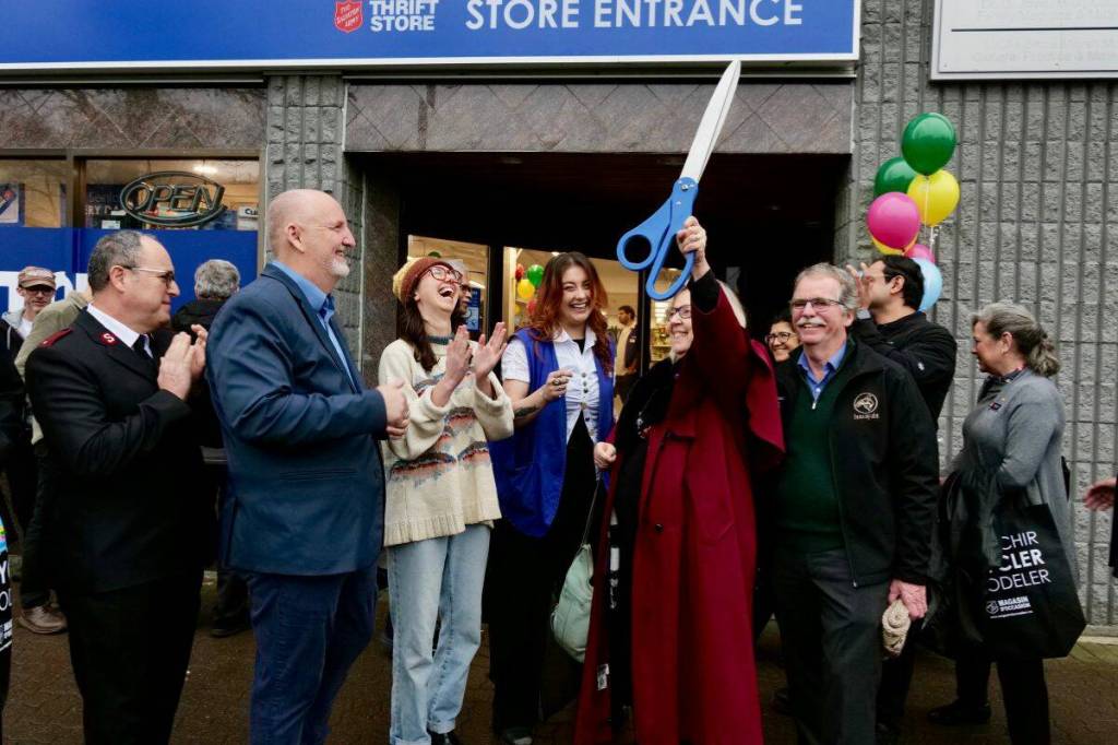 MP Elizabeth May holds the ceremonial scissors in the air after cutting the ribbon to open the Salvation Army store on March 19. (Tony Trozzo/Peninsula News Review)