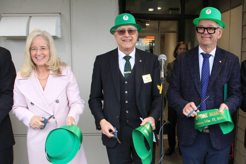 Mike Garisto (centre) cuts the ribbon to officially open Zappone Manor in Cloverdale. He&rsquo;s flanked by local MPs, and fellow ribbon cutters, Tamara Jansen and Ernie Klassen. Garisto said he was relieved to finally get the building open, as it&rsquo;s been a 10-year process. (Photo: Malin Jordan/Cloverdale Reporter)