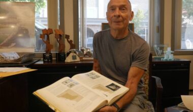 Dave Threatful, 80, at the Revelstoke Review office Sept. 11, 2025, with a copy of Butterflies of British Columbia, which was published in 2001 and references his namesake species, Polygonia oreas threatfuli. (Evert Lindquist/Revelstoke Review)