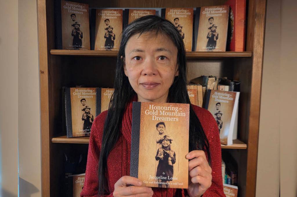 Calgary author Jacqueline Louie with her new book, Honouring the Gold Mountain Dreamers. (Photo courtesy Jacqueline Louie)