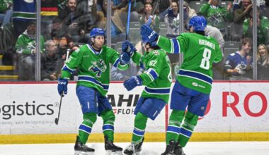 Abbotsford Canucks players congratulate Guillaume Brisebois after he scores a goal in his first home game this season on Saturday (March 28). (Abbotsford Canucks photo)