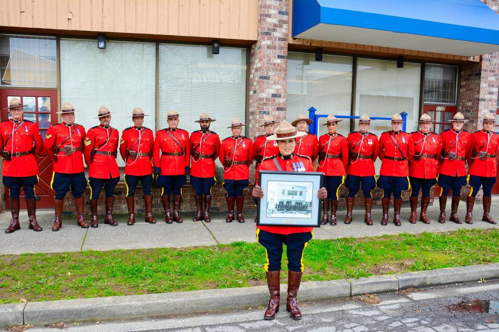 Current members of the RCMP Surrey Provincial Operations Support Unit replicate the original photo (held by Wendy Mehat) that was taken 75 years ago in May, 1951, when the RCMP first took over policing in the Surrey community of Cloverdale. (Photo submitted: RCMP)
