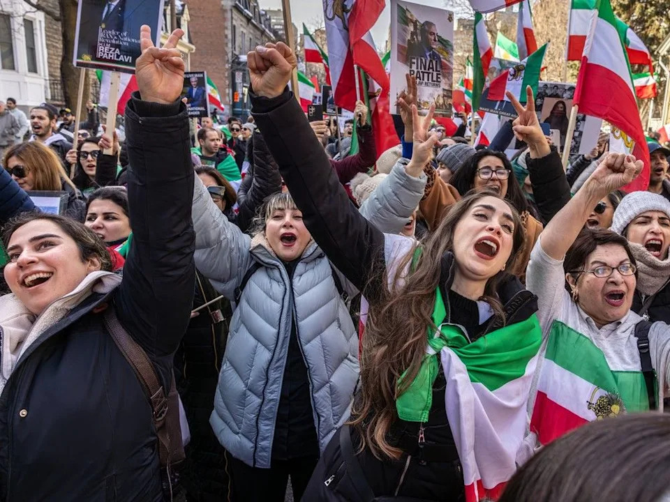  Iranian-Montrealers in a march in downtown Montreal on Saturday, Feb. 28, 2026, react to reports Iran’s Ayatollah Khamenei has been killed after a U.S.-Israeli attack.