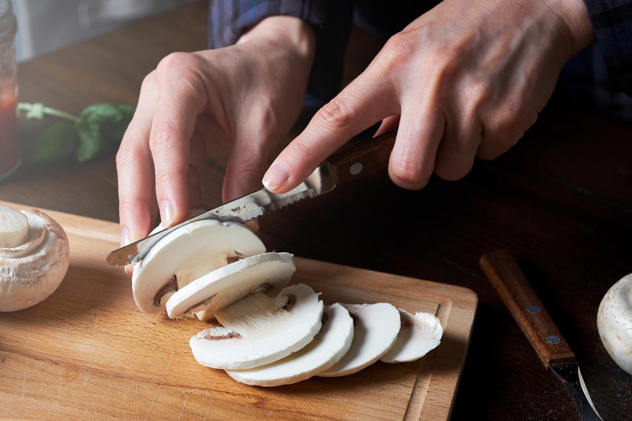 woman cutting mushrooms