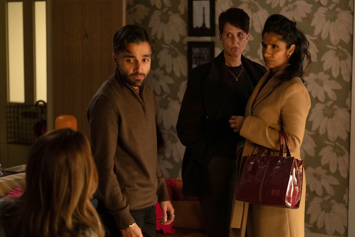 553695,TITLE:Eastenders Vinny, Suki and Eve stare towards Penny in a scene from EastEnders