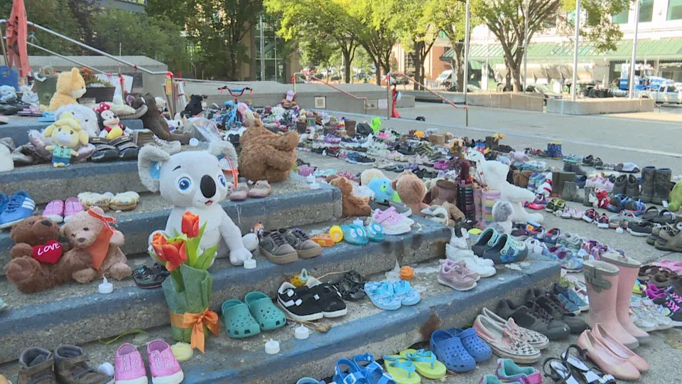 The steps of Calgary City Hall display hundreds of shoes, teddy bears and flowers in a memorial that was established by Indigenous communities in honour of the children that did not return home from residential schools.