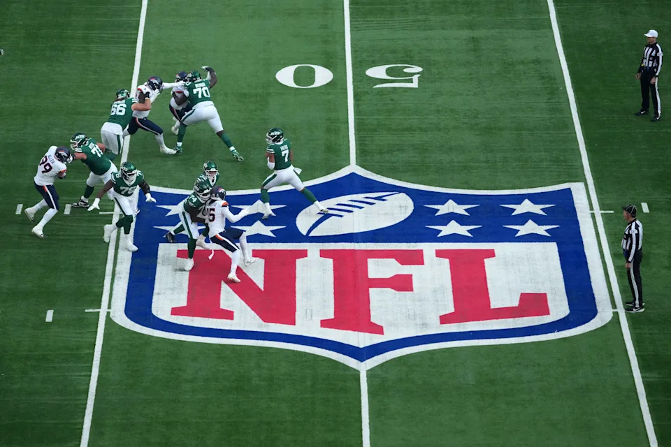 Oct 12, 2025; Tottenham, United Kingdom; A general overall view as New York Jets quarterback Justin Fields (7) throws the ball at midfield on the NFL shield logo in the first quarter against the Denver Broncos during an NFL International Series.