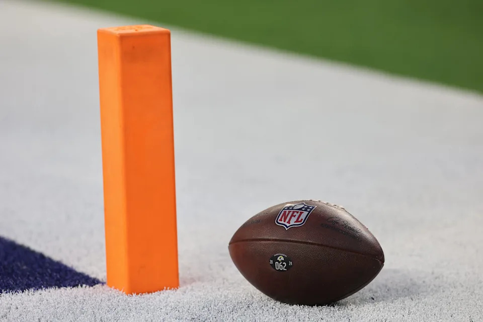 An official NFL football sits near the corner pylon of an end zone before the game between the Tampa Bay Buccaneers and the Los Angeles Rams at SoFi Stadium.