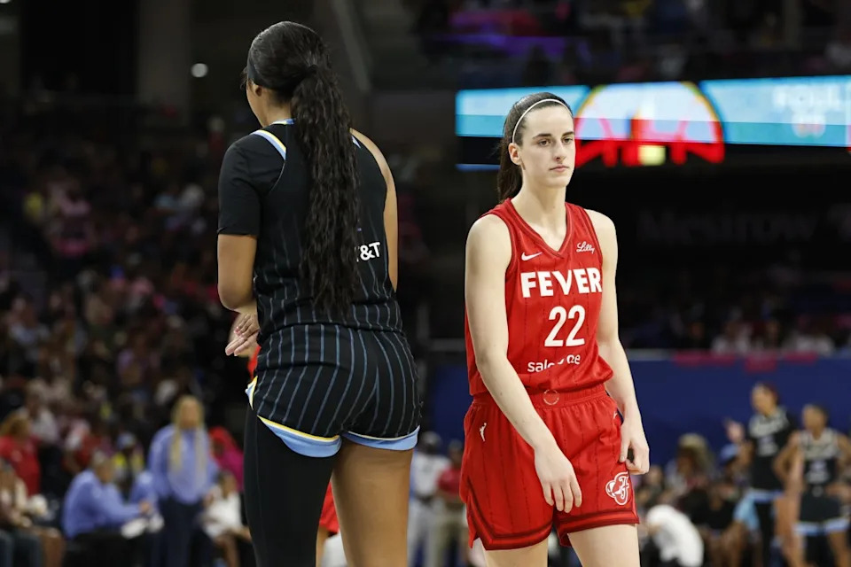 Indiana Fever guard Caitlin Clark (22) walks by Chicago Sky forward Angel Reese (5)Credit: Kamil Krzaczynski-Imagn Images