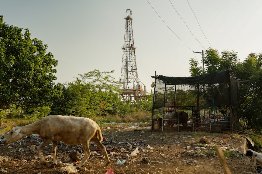 Ageing oil pump in the distance in dry country